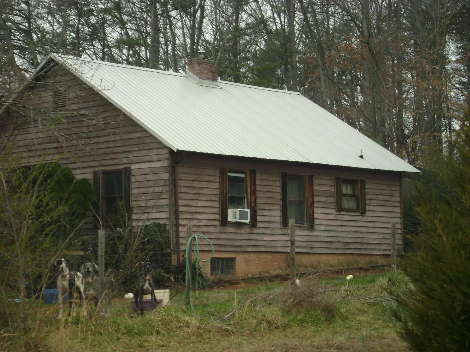 White metal roof on an old wood sided farmhouse, from a Metal Roof Installation job in Northville